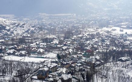 An aerial view of snow-covered rooftops after fresh snowfall, on the outskirts of Srinagar. Pic/PTI